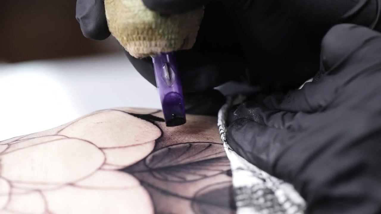 Artists talking inside the Blood Money Tattoo studio
